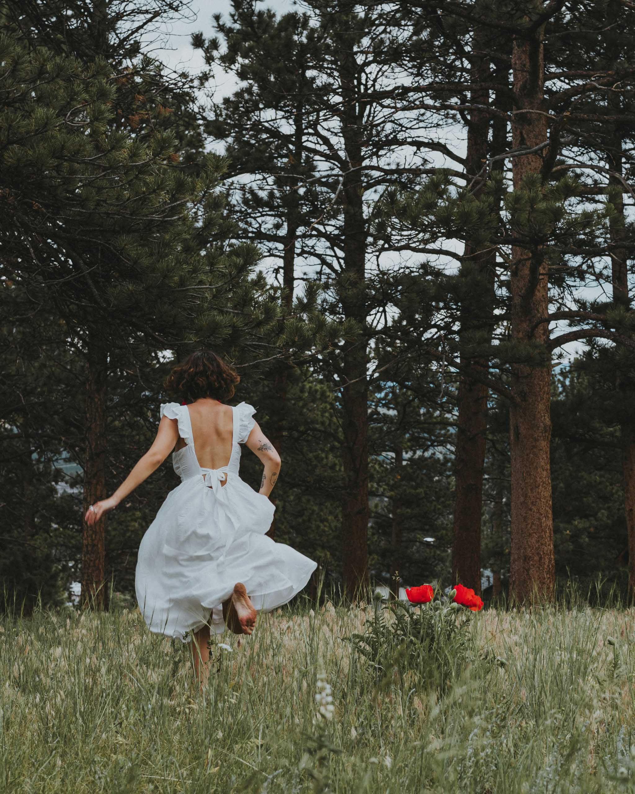 woman in white sundress in the woods