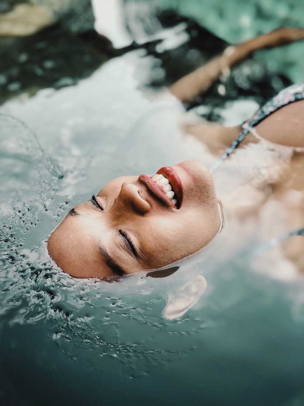 woman floating submerged in water